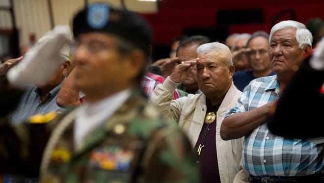 Vietnam veterans salute during the presentation of colors at a Vietnam veterans pinning ceremony at Navajo Technical University in Crownpoint on Sept. 22. Programs for Navajo veterans will receive additional funding under legislation recently enacted by Navajo lawmakers.