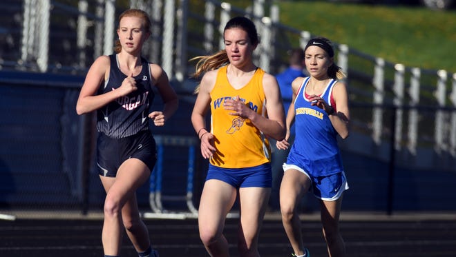 Morgan's Jozi Brown, left, West Muskingum's Megan Judson and Maysville's Molly Thompson run the 1600 meters during the Wayne Clark Invitational on Friday at John D. Sulsberger Memorial Stadium.