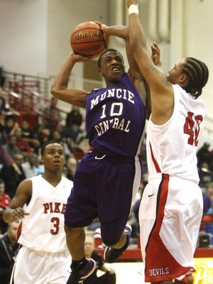 Central's Kaleb Mallory makes a layup past Pike's defense during their game at Pike High School on Tuesday, Dec. 28, 2011. Photo by Jordan Kartholl.