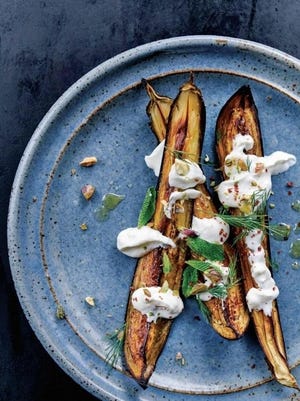 This roasted eggplant dish with a feta yogurt is from "Falastin" by Sami Tamimi, Tara Wigley and Yotam Ottolenghi. The tangy feta yogurt plays off the rich creaminess of roasted eggplant.
