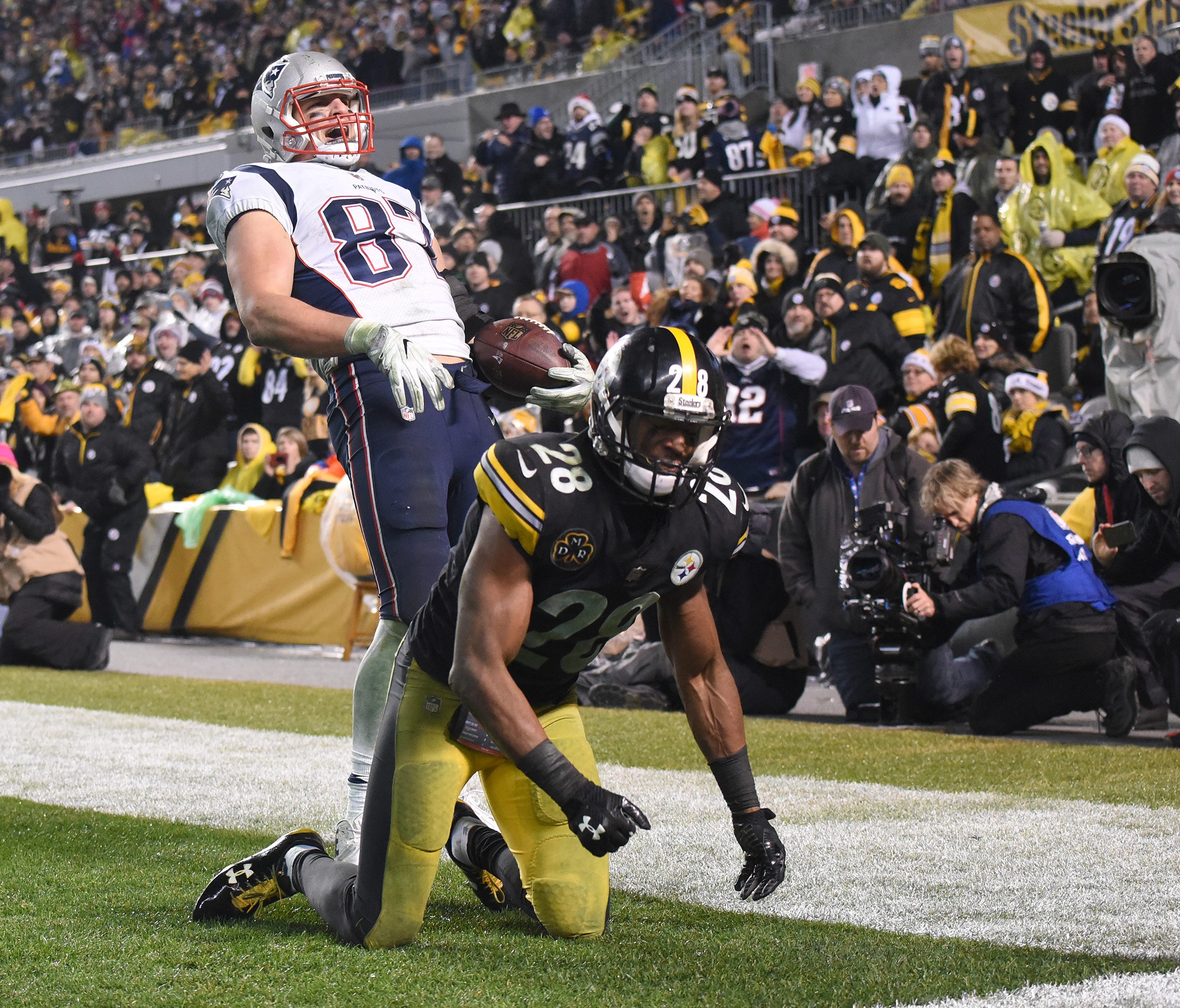 New England Patriots tight end Rob Gronkowski (87) celebrates a two point conversion in the fourth quarter as Pittsburgh Steelers safety Sean Davis (28) looks away at Heinz Field.