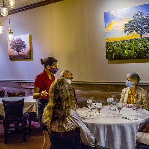 Hearth restaurant server Becky Welch talks with cu