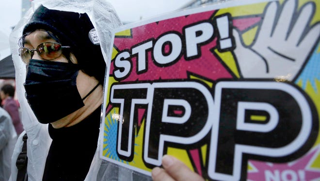 A protester holds a placard during a 2014 rally against the Trans-Pacific Partnership in Tokyo, Japan.