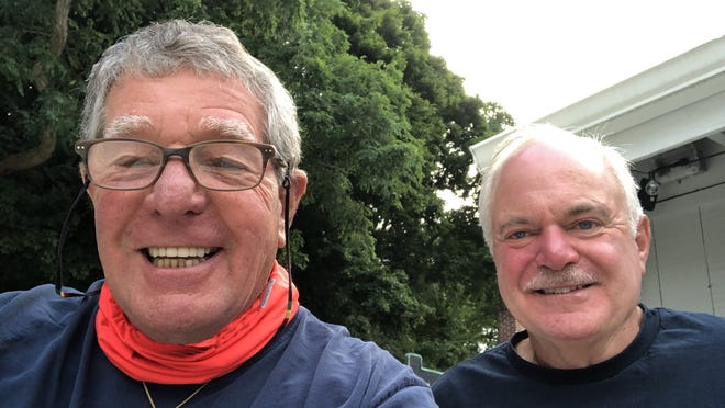 Paul Rifkin, of Mashpee, left, and Adam Lange, of Brewster, pose for a selfie after meeting for breakfast Aug. 7 in North Falmouth to talk about working together to tone down the hostility prevalent in today's political discourse. Rifkin was taken aback by the military truck with a .50-caliber machine gun mounted on the cab that Lange drives. Lange says the truck is a recruiting tool.