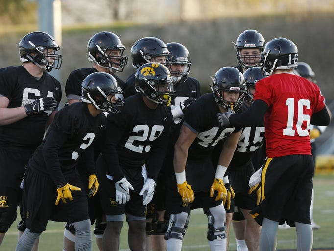 Iowa quarterback C.J. Beathard gives the play to his