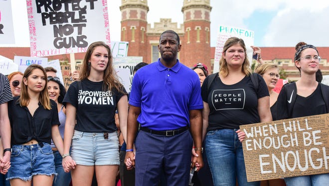 Tallahassee mayor Andrew Gillum marches with Florida State students down College Avenue to the Florida Capitol on Wednesday to support gun reform.