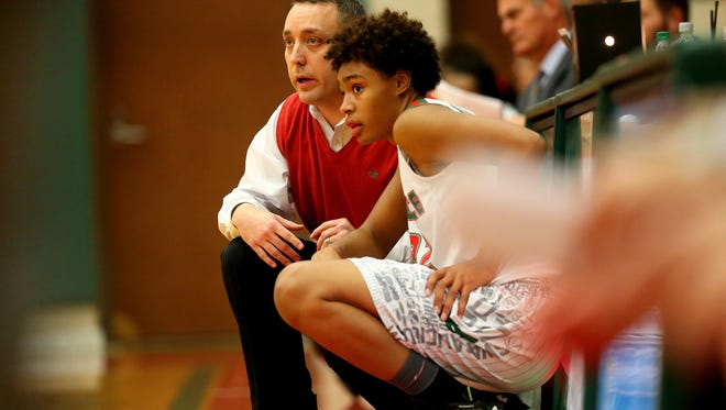 Lawrence North head girls basketball coach Chris Giffin waits on the sideline for a dead ball with Lawrence NorthÕs Ae'Rianna Harris (32) during the Carmel game on Dec. 1, 2015.