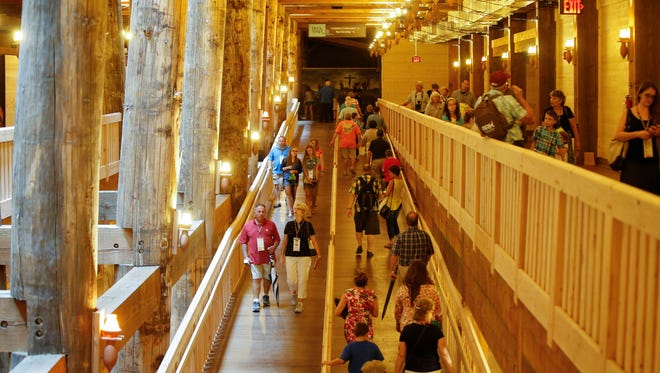 Visitors pass along the central support beams of a replica Noah's Ark at the Ark Encounter theme park during a preview day, Tuesday, July 5, 2016, in Williamstown, Ky. 