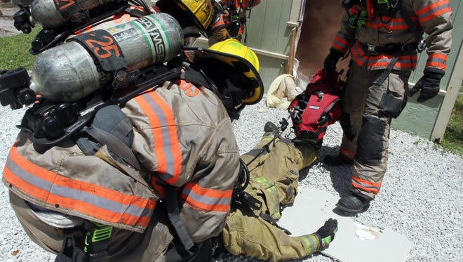 Bonita Springs firefighters save a fellow firefighter from simulated smoke inhalation. There was no fire at the house during Tuesday’s training session.