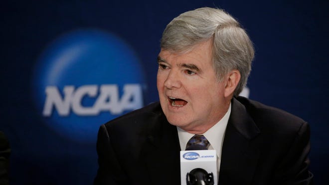 FILE - In this April 6, 2014, file phot, NCAA President Mark Emmert answers a question at a news conference in Arlington, Texas. Testifying in a landmark antitrust lawsuit filed against his organization, Emmert said Thursday, June 19, 2014, he believes there is a clear difference between the proposal to pay athletes a few thousand more dollars a year and giving them the equivalent of a salary. Emmert's testimony came in a much-anticipated appearance as the NCAA tries to convince U.S. District Judge Claudia Wilken that its system of so-called amateurism is not anti-competitive and is the best model for regulating college sports. (AP Photo/David J. Phillip, File)