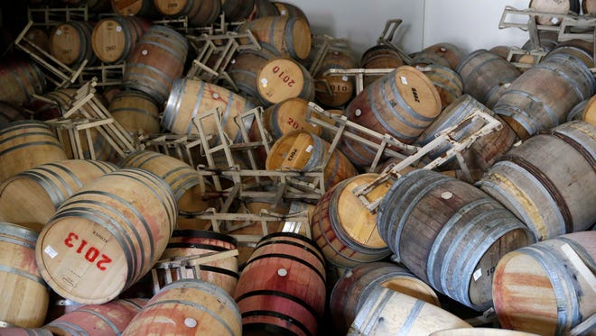 This Aug. 24, 2014, file photo shows barrels filled with Cabernet Sauvignon that toppled on one another following an earthquake at the B.R. Cohn Winery barrel storage facility in Napa, Calif.