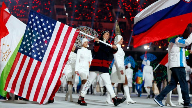 Feb 23, 2014; Sochi, RUSSIA; USA flag bearer Julie Chu during the closing ceremony for the Sochi 2014 Olympic Winter Games at Fisht Olympic Stadium. Mandatory Credit: Jeff Swinger-USA TODAY Sports ORG XMIT: USATSI-174798 ORIG FILE ID:  20140223_jla_usa_161.jpg