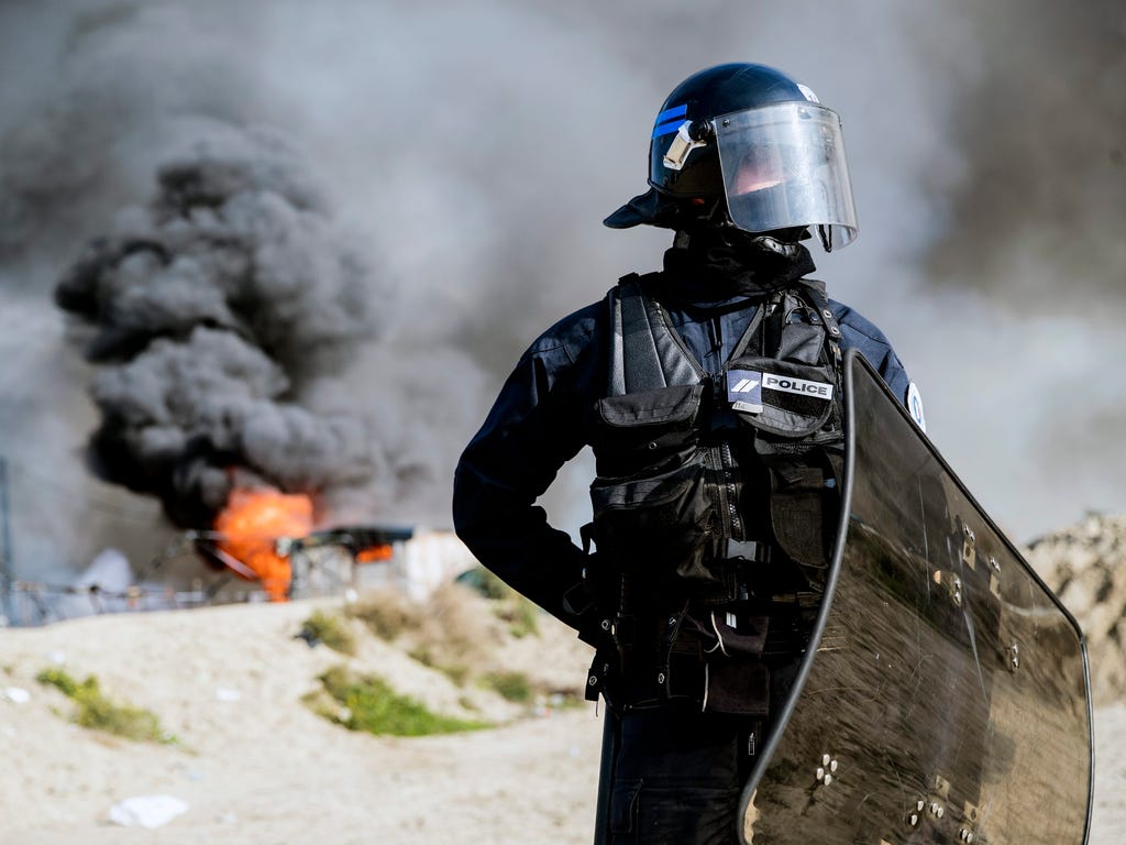 A French riot-police officer blocks access to the makeshift camp dubbed \