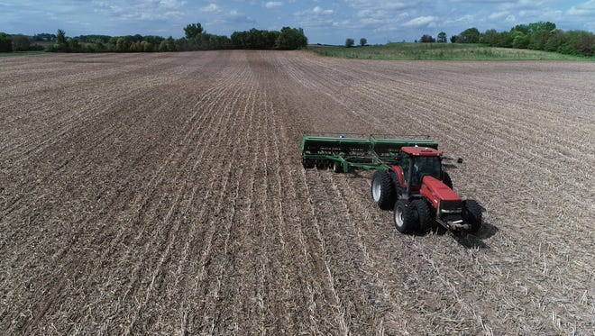 A farmer plants soybeans in a field near Perry on May 22, 2018.