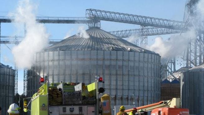 Smoke pours from holes in a grain bin in Brokaw after an explosion in January 2011.