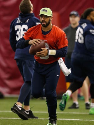 Quarterback Russell Wilson #3 of the Seattle Seahawks warms up during a practice at Arizona State University on January 30, 2015 in Tempe, Arizona.