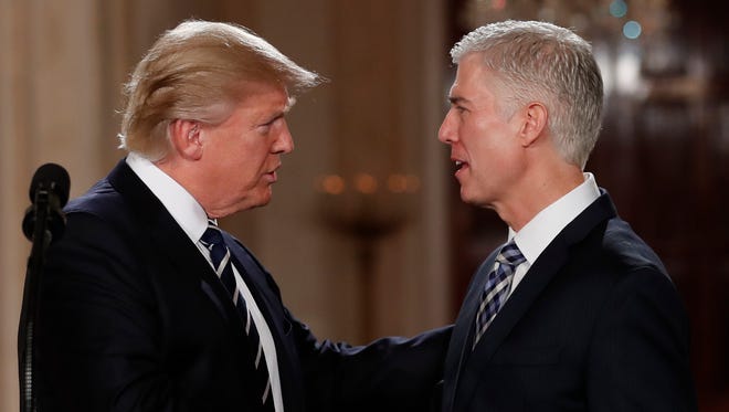 President Donald Trump shakes hands with 10th U.S. Circuit Court of Appeals Judge Neil Gorsuch, his choice for Supreme Court Justices in the East Room of the White House in Washington, Tuesday, Jan. 31, 2017. (AP Photo/Carolyn Kaster)