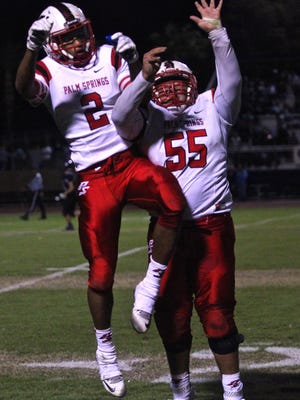 Indians' Tayler Hawkins (2) and Adrian Olvera (55) celebrate a touchdown during an away match in Cathedral City on Friday.