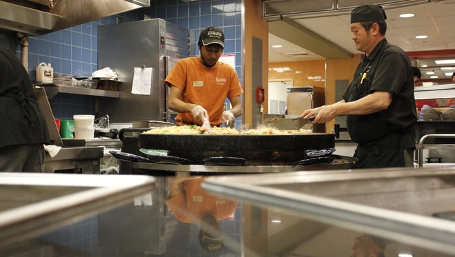 Earhart Dining Court workers make stir fry for dinner on Friday night.