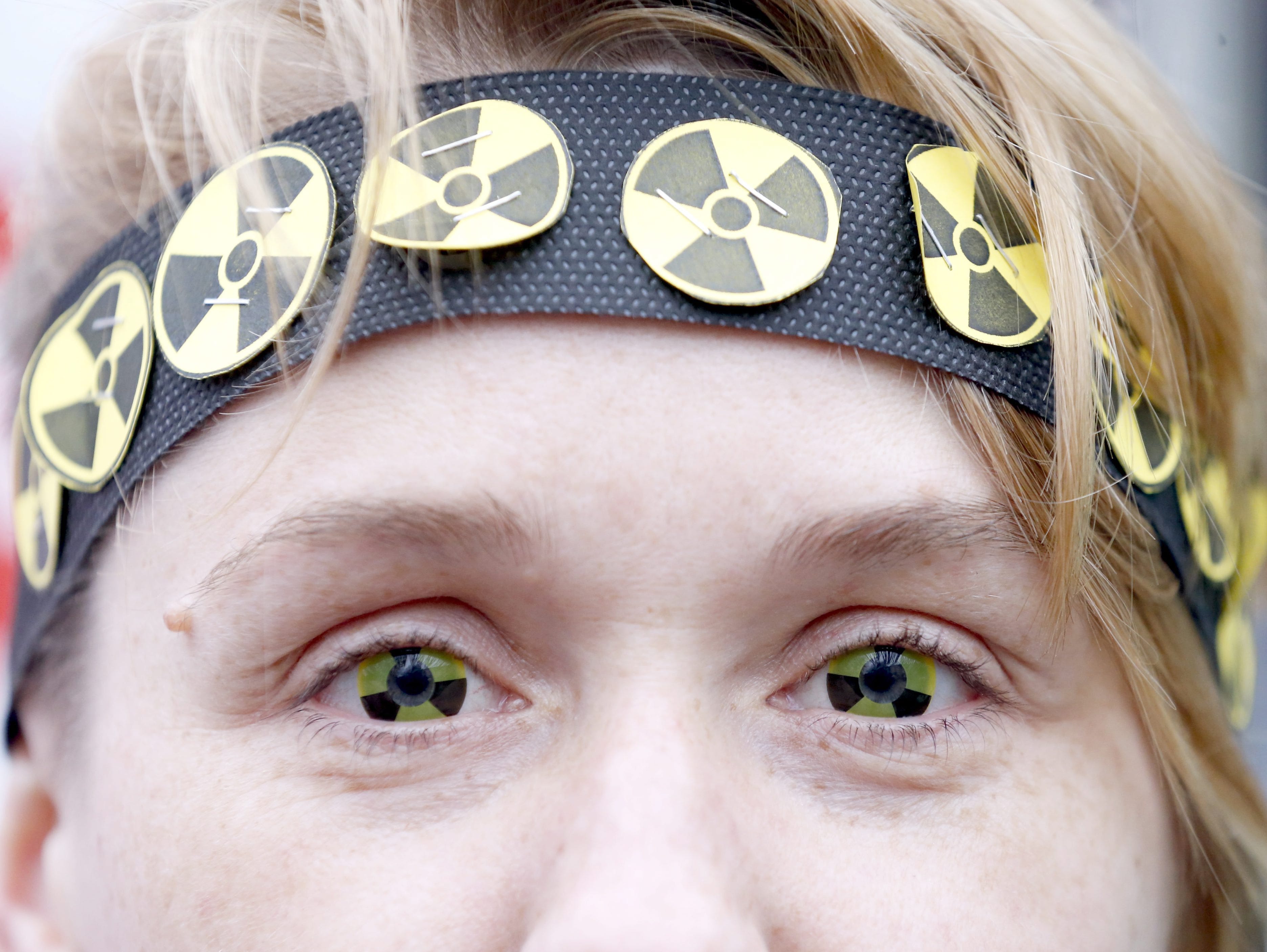 A protester wears eye-lenses with radioactive signs, as she participates in a rally to mark the 30th anniversary of the Chernobyl nuclear disaster in Minsk, Belarus on April 26, 2016.