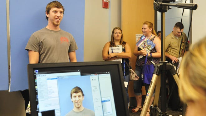 Transfer student Austin Young, from Roane State Community College, gets his MTSU identification card picture made during a special orientation for transfer students on June 23.