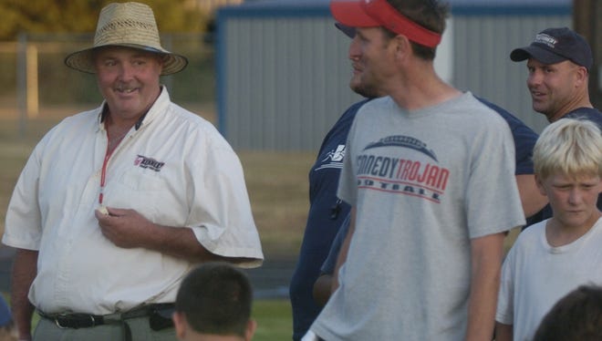 Kennedy coach Randy Traeger shares a laugh with players Thursday during football camp in 2011.