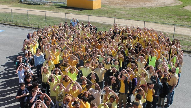 This April 1, 2015 photo shows Crisfield High School students in the formation of a heart, many of them wearing yellow. The display was in memory of fellow student Andrea Nichole Joyner, a 15-year-old 10th grader who died March 27 in a vehicle accident. Yellow was Andrea’s favorite color, school officials said.