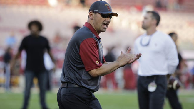 USC Head Coach Steve Sarkisian excites his players before Thursday’s game against Washington. The Huskies beat the Trojans, 17-12, and Sarkisian was fired Monday.