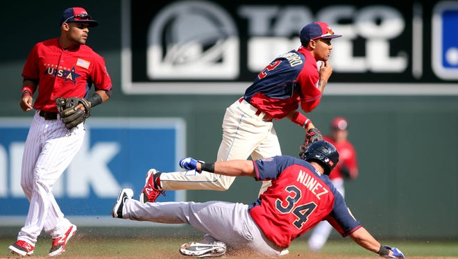 USA infielder J.P. Crawford (top) turns a double play over World infielder Renato Nunez in the 4th inning July 13 during the All Star Futures Game at Target Field. Credit: Jerry Lai-USA TODAY Sports