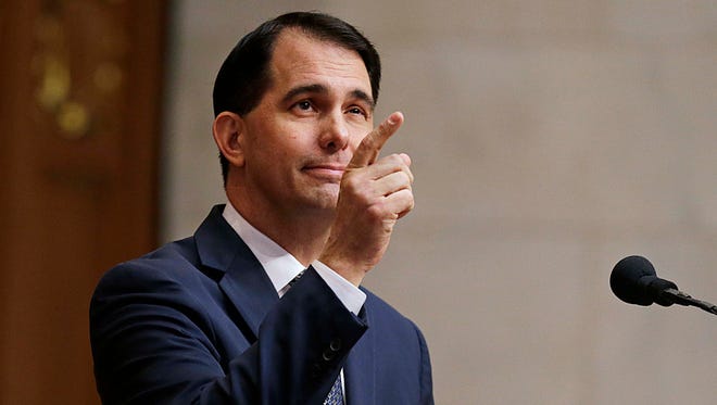 Wisconsin Governor Scott Walker winks and acknowledges an invited guest as he delivers his "state of the state" address during a joint session of the Wisconsin State Legislature.