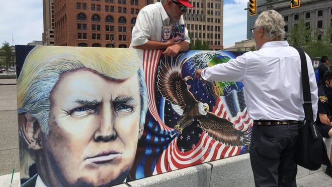 Julian Raven shows a  painting of Donald Trump in Cleveland on July 17, 2016.