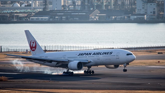 A Japan Airlines (JAL) Boeing 777 is seen landing at Tokyo's Haneda Airport on Jan. 28, 2016.