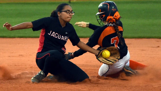 Port St. Lucie's Jasmine Rodriguez tags out Lincoln Park Academy's Storm White at second base Tuesday, Mar. 7, 2017, during their high school softball game at the Lawnwood Softball Complex in Fort Pierce.