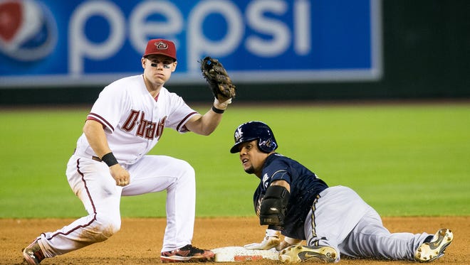 Arizona Diamondbacks shortstop Chris Owings tags out Milwaukee Brewers' Carlos Gomez during their game at Chase Field in Phoenix on Thursday, June 19, 2014.