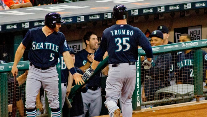 Seattle Mariners Mark Trumbo is greeted after hitting a home run against the Houston Astros  in the second inning of a baseball game Monday, Aug. 31, 2015, in Houston.