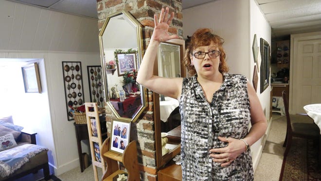 Diana Lyons talks Friday, June 5, 2015, about chunks of plaster falling from the ceiling of her third floor apartment inside the historic Blackstock Nargi House at 904 State Street in Lafayette. Lyons said several large pieces of plaster have fallen from the ceiling. Lyons said she was bitten by a bat in the late afternoon on Wednesday, May 27, when she walked into the apartment. She believes she was bitten when she raised her hand to push the bat away from her head.