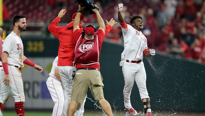 Cincinnati Reds second baseman Dilson Herrera (15) hits a walk-off single to win the game in the ninth inning during a National League baseball between the St. Louis Cardinals and the Cincinnati Reds, Monday, July 23, 2018, at Great American Ball Park in Cincinnati. 