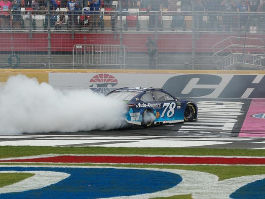 Martin Truex Jr. performs a burnout after winning at