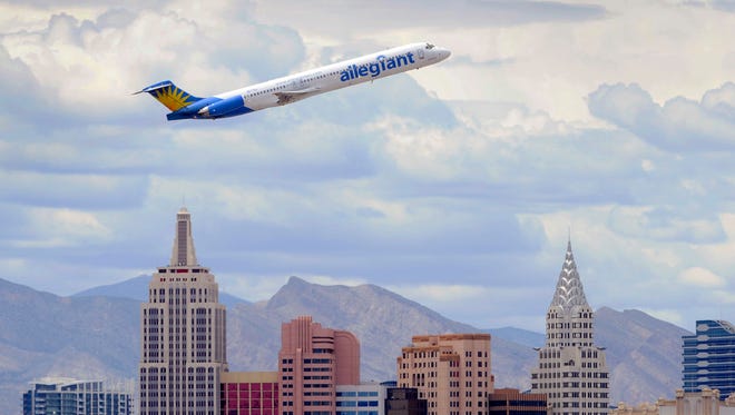 An Allegiant Air jetliner flies over the the the New York-New York Hotel & Casino after taking off from McCarran International Airport in Las Vegas on May 9, 2013.