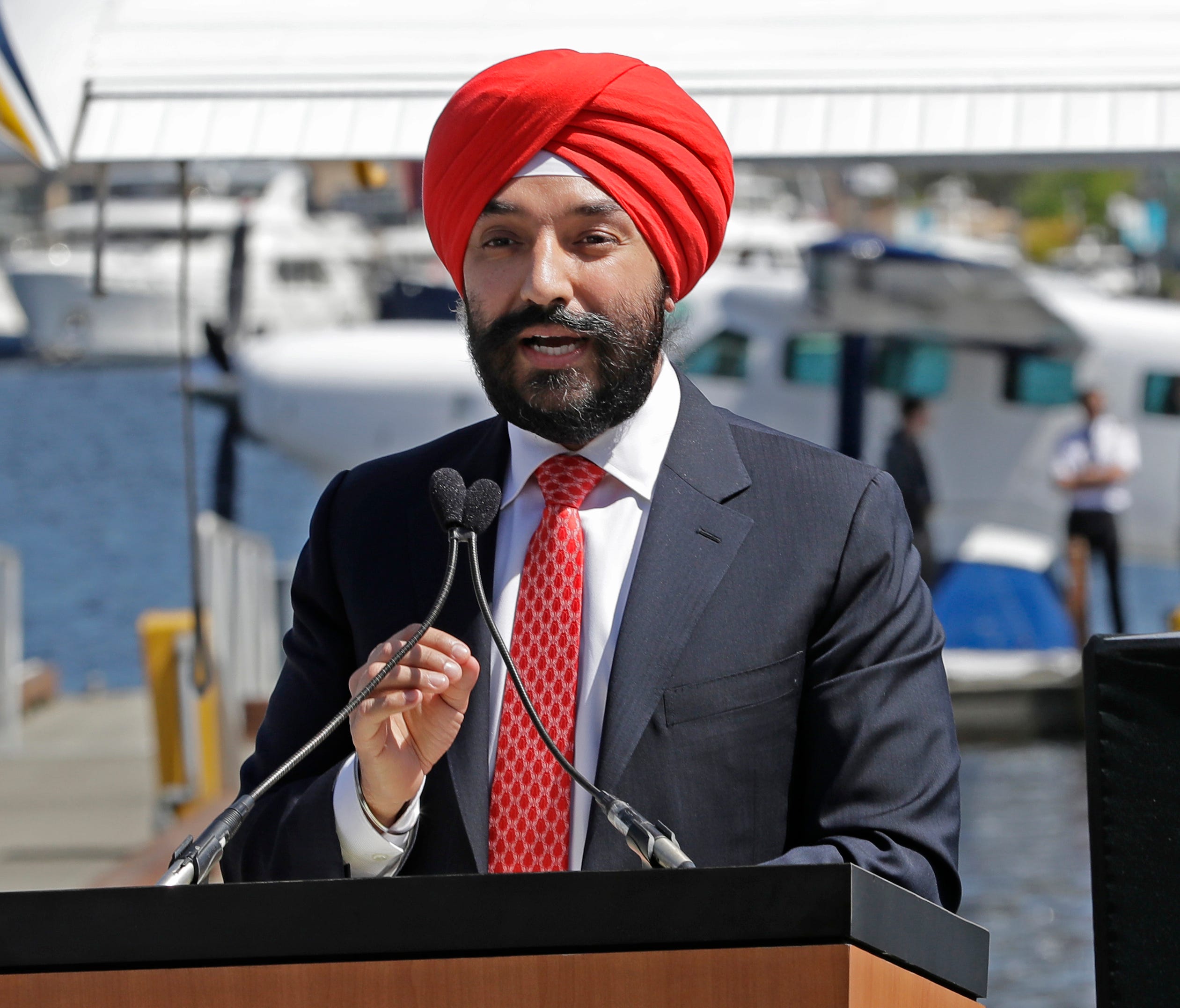 Navdeep Bains, Canada's Minister of Innovation, Science and Economic Development, is pictured speaking in Seattle at a news conference announcing the partnership between Harbour Air and Kenmore Air.