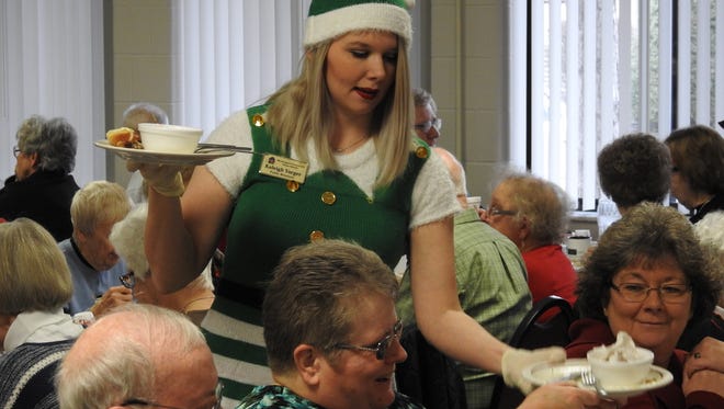 Volunteer Kaleigh Yarger dressed as an elf Thursday while serving diners during the Coshocton Senior Center's Annual Christmas luncheon.