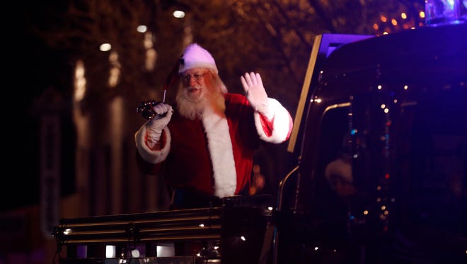 Santa Claus rides down Farmington's Main Street on Thursday during this year's annual Christmas parade.