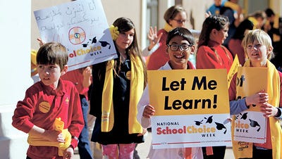 Jack Bensch, 9, a 4th grade student at the New Mexico International School, holds a sign at a rally for National School Choice Week outside of the state capitol on Thursday.