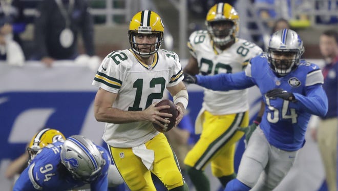 Green Bay Packers quarterback Aaron Rodgers runs for yardage in the third quarter Sunday, January 1, 2017, at Ford Field in Detroit, Mich.