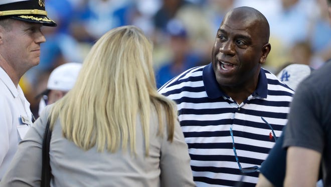 Magic Johnson arrives before Game 4 of the National League championship series between the Chicago Cubs and the Los Angeles Dodgers on Wednesday, Oct. 19, 2016, in Los Angeles.