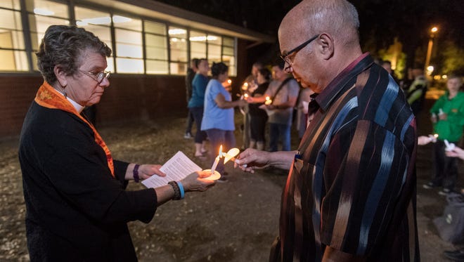Rev. Suzy Ward, left, Councilman Steve Nelsen and other community members gather outside Visalia City Hall on Monday, October 2, 2017 to pray for victims of the Las Vegas shooting.