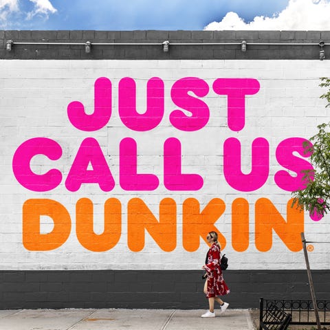 Large sign reading Just Call Us Dunkin painted on 