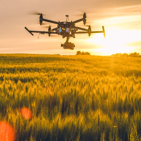 A drone hovers over a field.