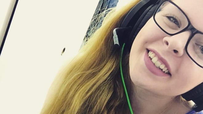 Simone Hoagboon, 19, puts on her headset pre-stream and smiles for a selfie.