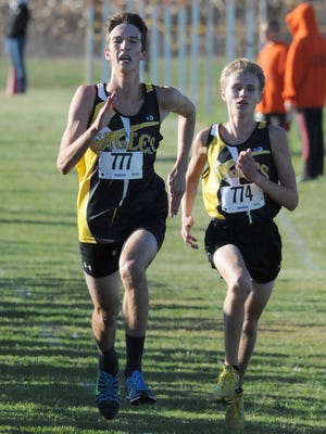 
Clay Martin and Chad Johnson of Col. Crawford sprint to the finish line Saturday during the N10 Cross Country Championships at Seneca East High School in Attica. 
